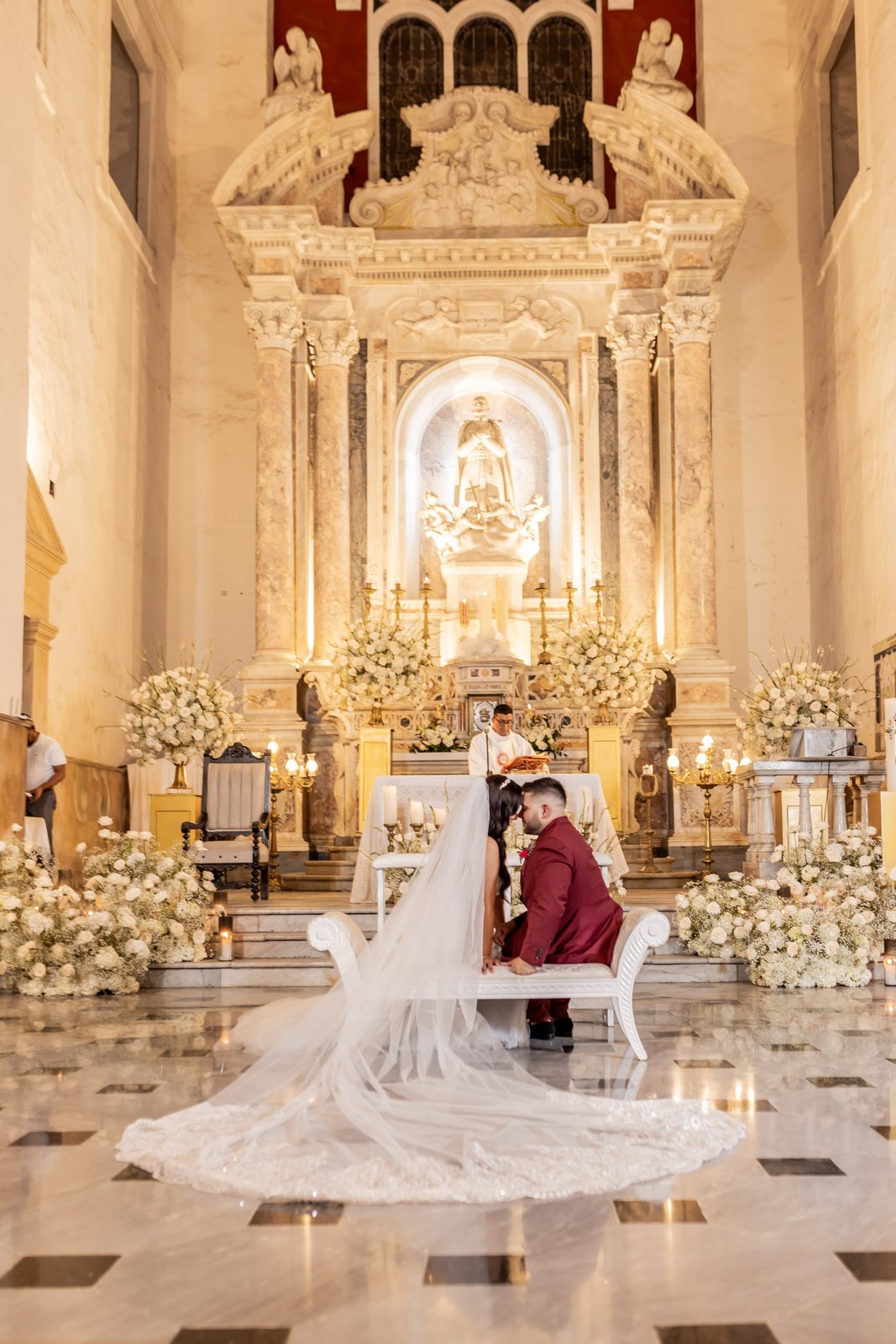 Pareja de novios frente al altar barroco de la iglesia de San Pedro Claver en Cartagena